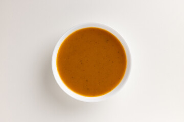 A top view of a round white bowl filled with winter vegetable purée, set against a white background. Simple, clean design, perfect for food styling, product mockups, or promotional use.
