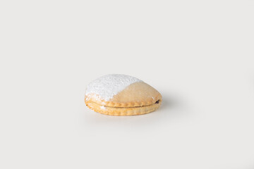 A delicate Cassatella di Agira, a traditional Sicilian pastry filled with chocolate and a hint of citrus, dusted with powdered sugar, set against a clean white background.