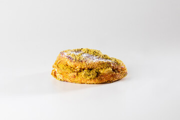 A flaky pastry filled with creamy ricotta and pistachio, showcasing the perfect combination of...