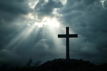 Cross and empty tomb with glowing rays of light