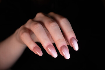 Glossy nude manicure with a "cat eye" effect on oval-shaped extended nails creates an elegant and sophisticated look. The shine enhances the depth and shimmer of the coating.