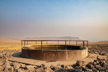 A weathered water trough provides essential hydration for livestock and wildlife in the arid Smoke...