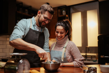 Couple enjoying cooking together in modern kitchen