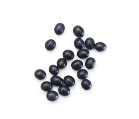 Pile of black beans in wood bowl isolated on white background