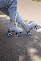 Close-up of girl's legs in quad rollerblades. Vertical photo. High quality photo