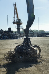Large excavators work on scrap metal