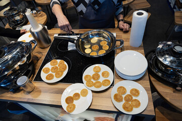 Frying mini pancake cereal in a nonstick frying pan.