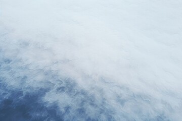 Obraz premium Aerial view of white fluffy clouds on blue sky. Dreamy cloudscape, cloudy weather. Abstract blue and white gradient background 