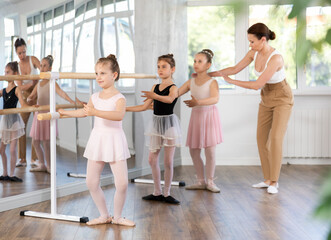 Lesson for little ballerinas - girls learn to dance ballet in a choreographic class © JackF