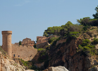 Fototapeta premium Coastal Castle with Tower and Lush Greenery