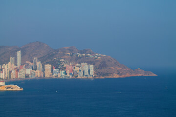 Fototapeta premium Coastal City Skyline with Mountains and Sea