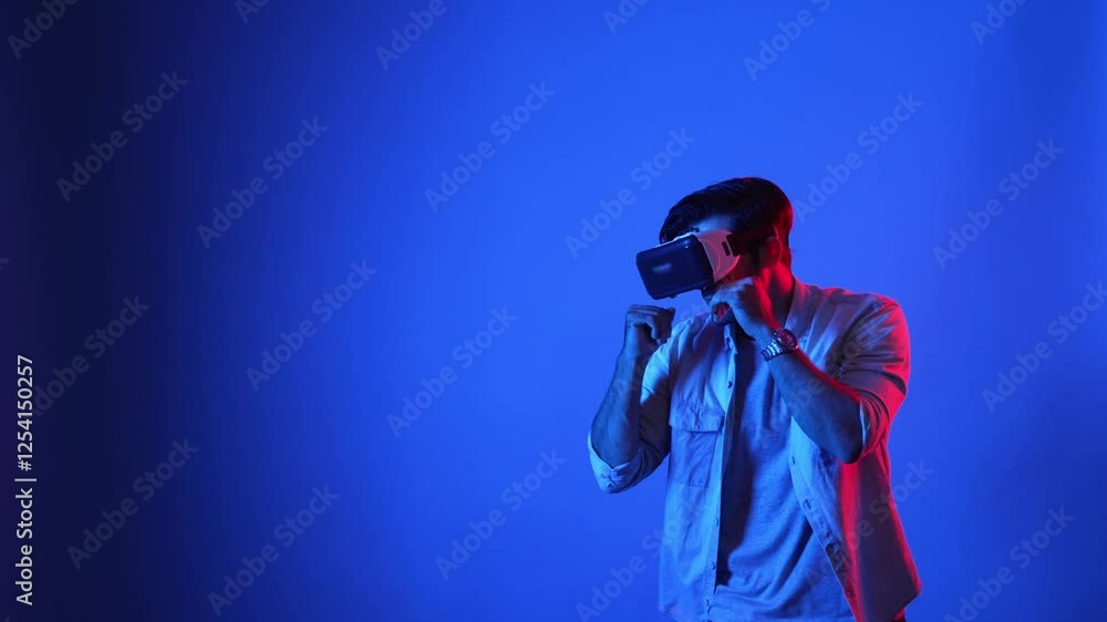 Poster skilled gamer making a punching posture by using virtual reality technology. side view of smart male