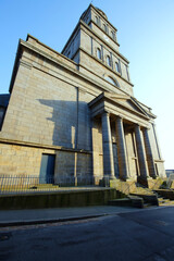 Obraz premium The 18th century Roman Catholic church Sainte Croix located in Saint-Servan. It stands out in the landscape with its blue granite architecture and its square tower topped with a dome.