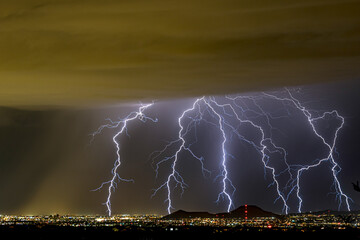 Tucson Arizona's Monsoon seasonal thunder and lightning storms over the downtown and A mountain...