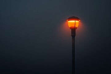 Street lamp on pole, black background, foggy night, orange light from top, minimalist style, low angle, wide-angle lens, shallow depth of field, dark cinematic mood.