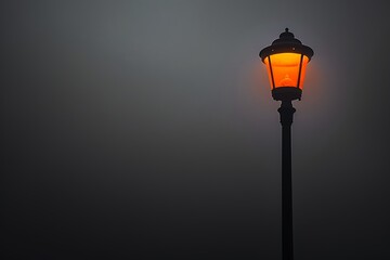 Street lamp on pole, black background, foggy night, orange light from top, minimalist style, low angle, wide-angle lens, shallow depth of field, dark cinematic mood.