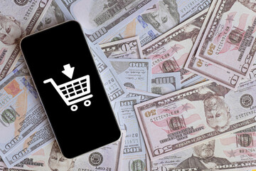 Smartphone displaying shopping cart icon placed on dollar banknote, digital shopping, mobile...