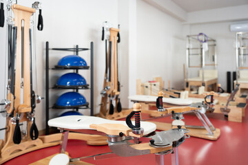 In modern gym there is equipment for Pilates training -reformer bed, multifunctional bench, pilates apparatus with rope. Doing sports without pain and overexertion. Sport as lifestyle