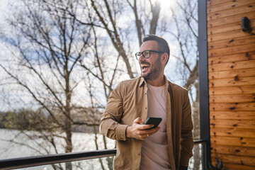 One adult man at home use smart phone app browse internet or send sms