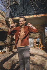 Portrait of one man happy caucasian male with travel bag at his house