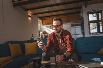 One adult man at home use smart phone app browse internet or send sms