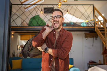 Portrait of one man happy caucasian male with travel bag at his house