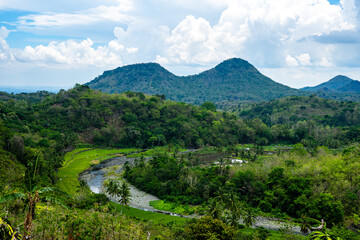 Fototapeta premium Tropical Landscape with Rolling Hills and River