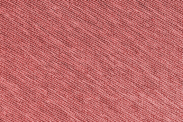 Closeup, macro of red fabric texture background. Satin diagonal weaving cloth structure, canvas. Textile for decor, upholstery, garment. Wallpaper, backdrop.
