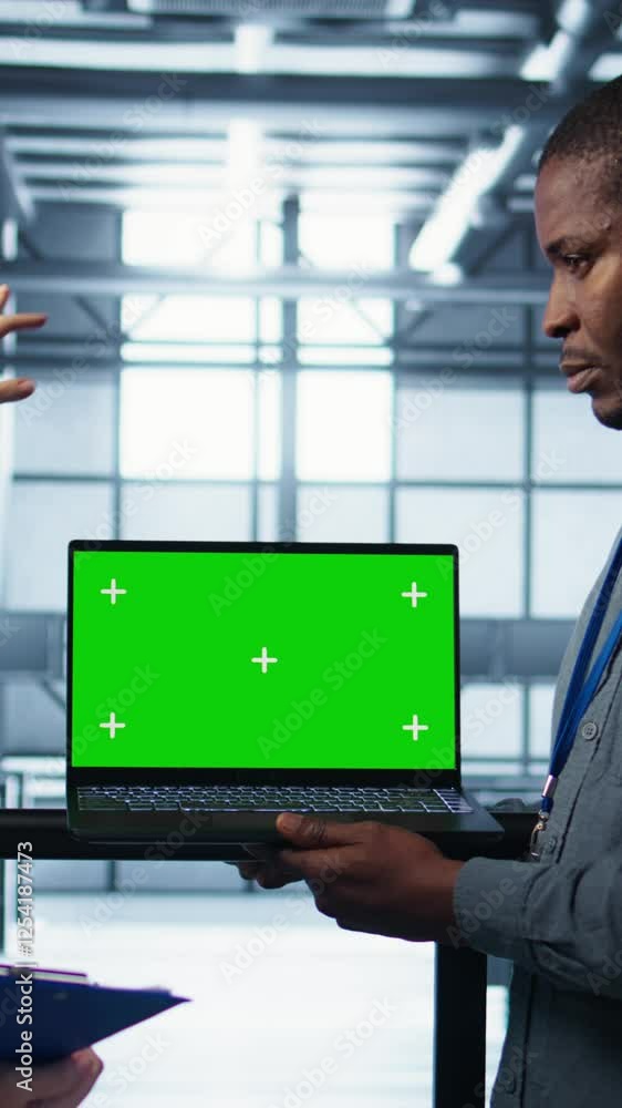 Poster vertical video engineering team in data center using green screen laptop, implementing predictive an