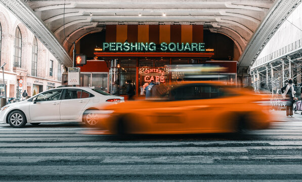 New York, USA: taxi moving fast ahead Pershing Square restaurant next to Grand Central Station