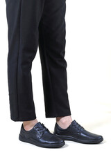 man's feet with shoes on a white background