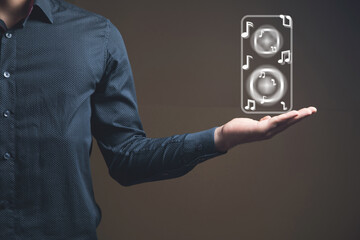 man presses virtual screen on speaker with notes