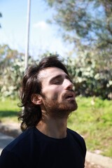 Italian Man with Long Hair Breathes Concentrated Pure Air in the Mountains