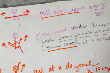 Hand written strength training instructions for using resistance bands