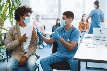 flu Vaccination. Vaccinated African American Guy And Doctor Gesturing Thumbs Up Looking At Each...