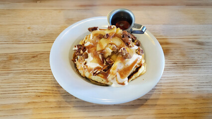 Apple Spice pancakes topped with whip cream and sugar pecans