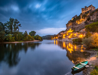 Stunning twilight view of Beynac village and river reflects serene lights
