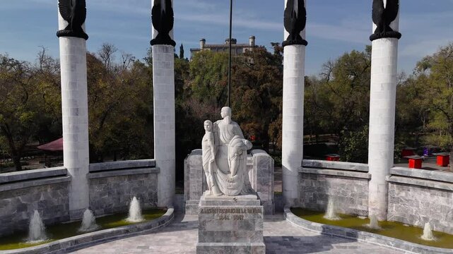 Chapultepec Castle and Monument to the Boy Heroes in Mexico City. Drone rises from the monument and moves backwards to reveal the castle