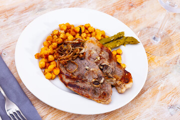 Delicious meat dish with lamb steak, yellow chickpeas and green asparagus