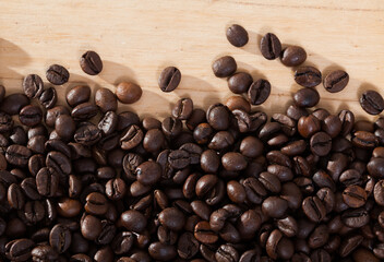 Image of fresh coffee beans on natural wooden background, nobody