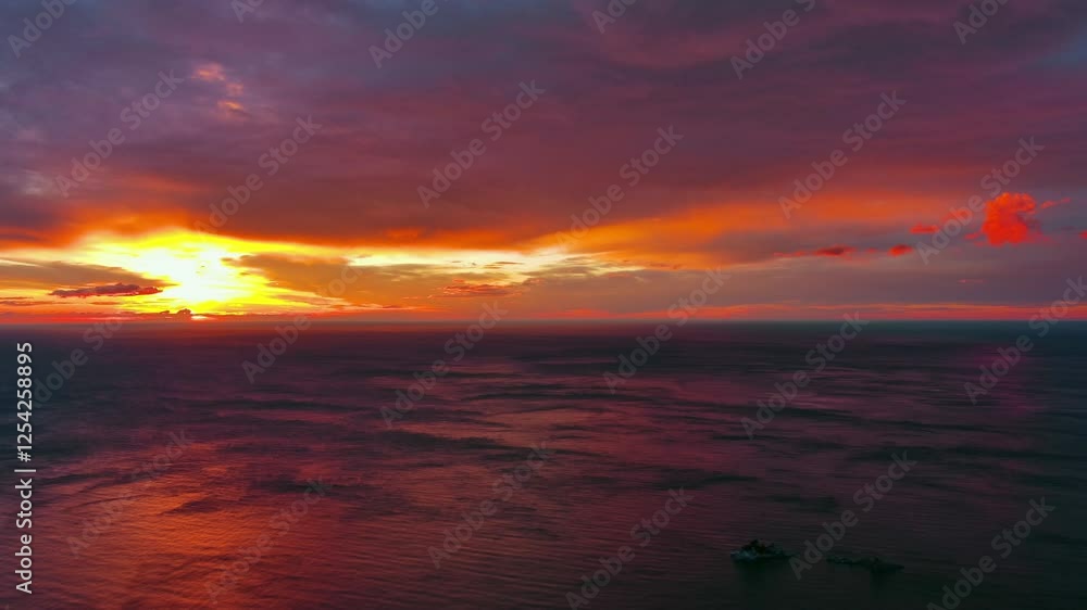 Wall mural aerial view of sea surface during a dramatic red sunset, timelapse, 4k