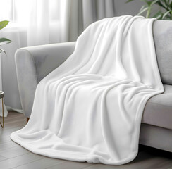 White Fleece Blanket Throw30 x 48inch soft white smooth thin velveteen plush blanket sitting on top of and over the back of the couch with the arms outstretche