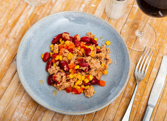 Plate of light and nutritious salad made with tender crushed tuna, kidney beans, sweet corn, and fresh vegetables served in simple style. Mexican cuisine..