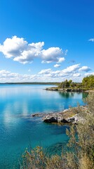 Fototapeta premium Lakeside scenic view, calm water, sunny day, natural beauty