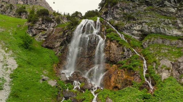 Wasserfall am Nebelhorn Luftaufnahme. Waterfalls in gorge near Mount Nebelhorn in Bavaria, Germany in summer aerial view. Waterfall in rock gorge of Alps. Valley with waterfall near Obersdorf. 