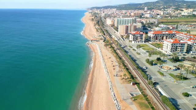Stunning aerial view capturing the beautiful coastline and beachfront of pineda de mar in maresme, barcelona, with vibrant waters and urban landscape