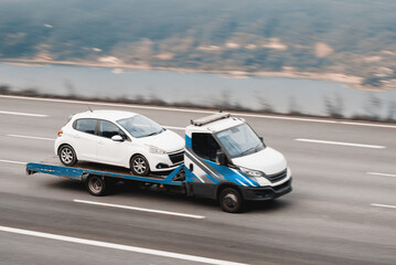 Vehicle Transportation Truck In Motion Blur Carrying Car On Flatbed With Sharp Focus