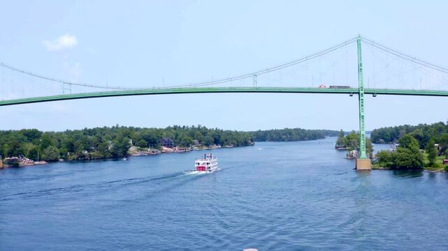 Paddle Boat Cruise Ship on St. Lawrence River Passes under the Thousand Islands in Alexandria Bay, New York - Aerial Drone View in HD and 4K