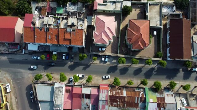 Top down drone shot above streets and houses in Maputo city, in sunny Mozambique