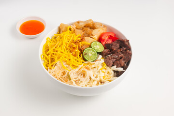 Soto Mie Bogor. Traditional Sundanese Beef Noodle Soup with Spring Roll, Cabbage, and Tomato. Street Food from Bogor, West Java, Indonesia. Perfect for recipe, article, catalogue.